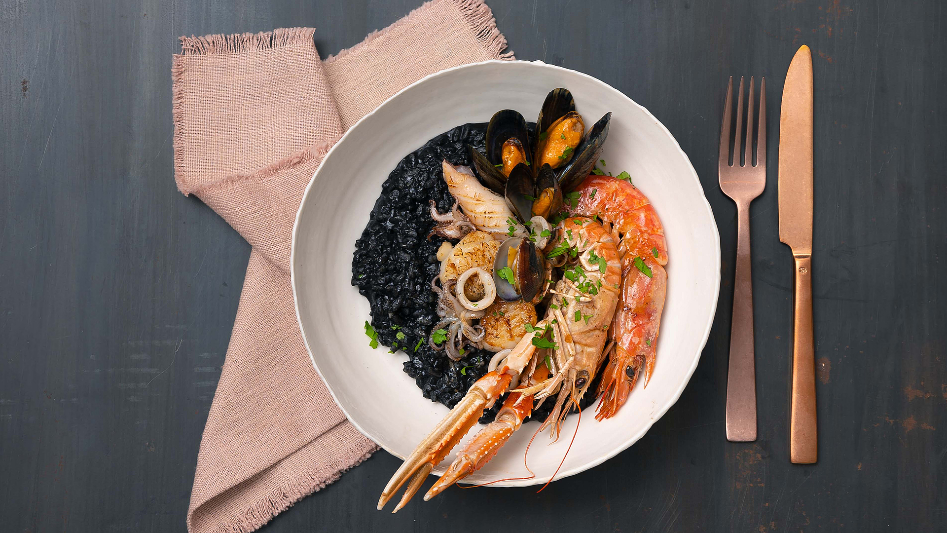 Black risotto with crustaceans