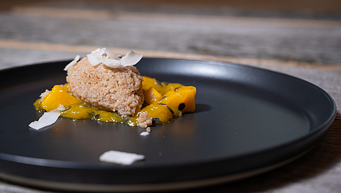Coconut couscous with mango and passion fruit compote