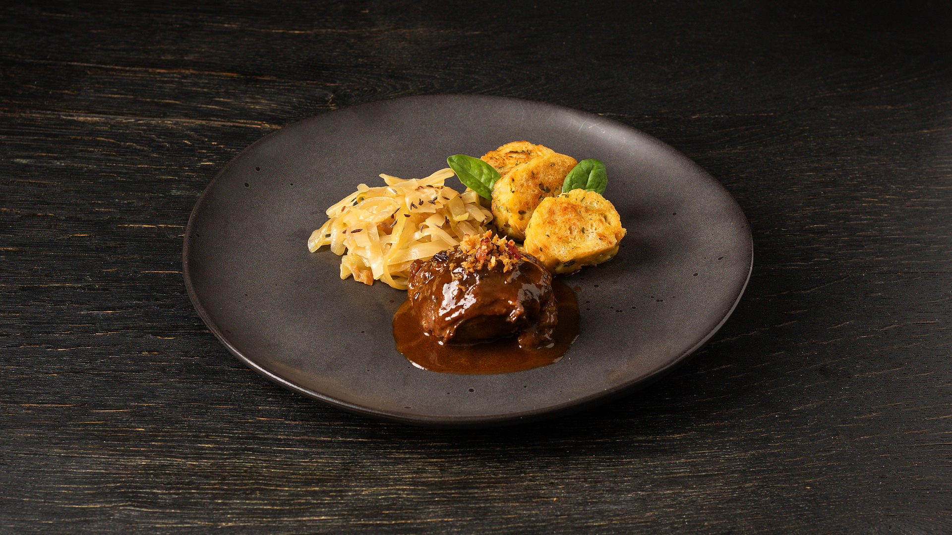 Pork cheeks with bread dumplings and Bavarian cabbage